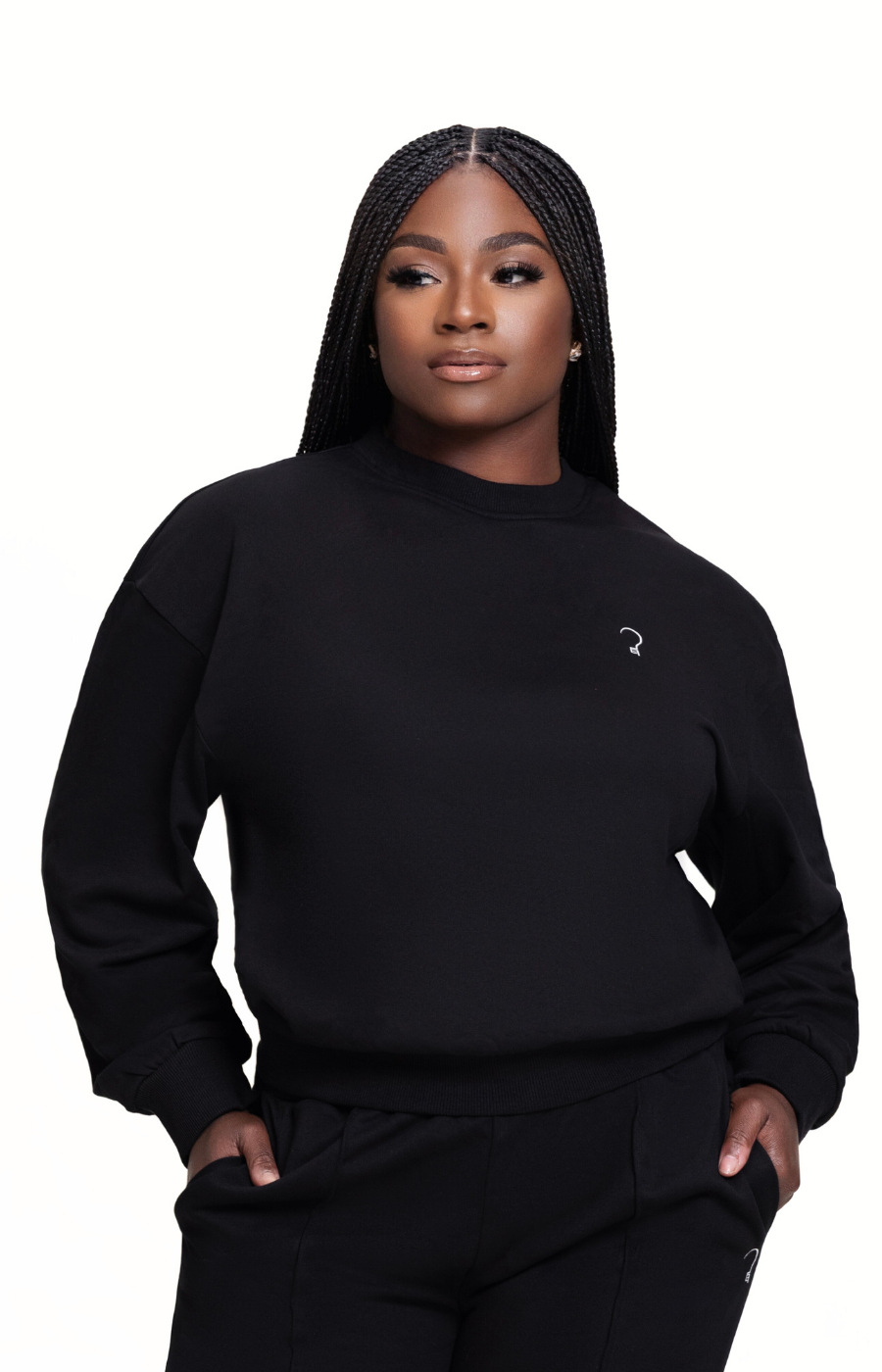 Woman wearing a black sweatshirt with a small logo on a white background